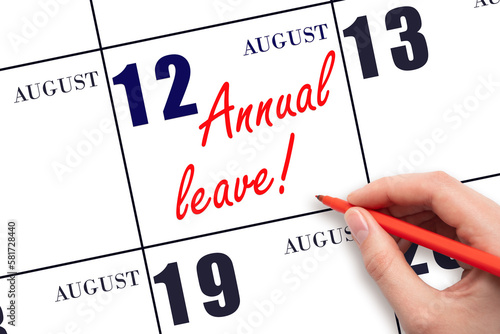 Hand writing the text ANNUAL LEAVE and drawing the sun on the calendar date August 12