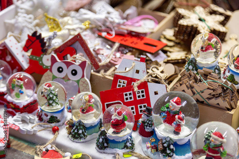 European Christmas market stall in  Old Town. colorful Christmas ornaments are some of the most popular souvenirs with tourists at seasonal fairs.