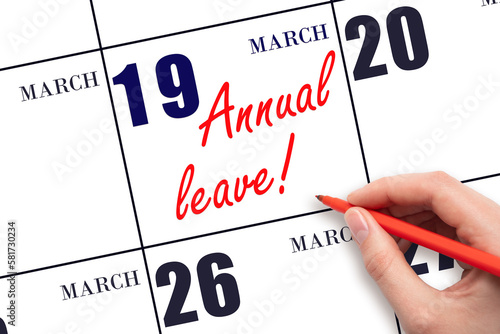 Hand writing the text ANNUAL LEAVE and drawing the sun on the calendar date March 19