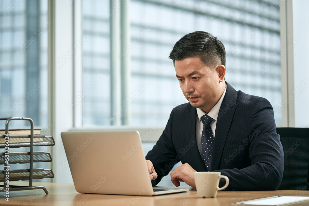 asian business man working in office using laptop computer asian business man working in office using laptop computer