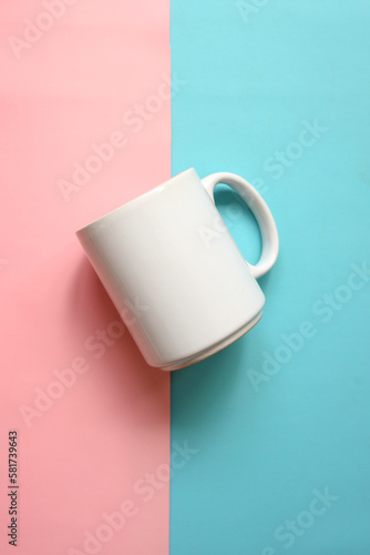 White mug isolated on blue pink pastel color background, white porcelain mug mock up. 
