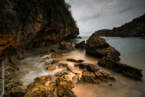 Beautiful beach at low tide and you can see lots of coral and seaweed on the beach while sunset or sunrise. © Rizky