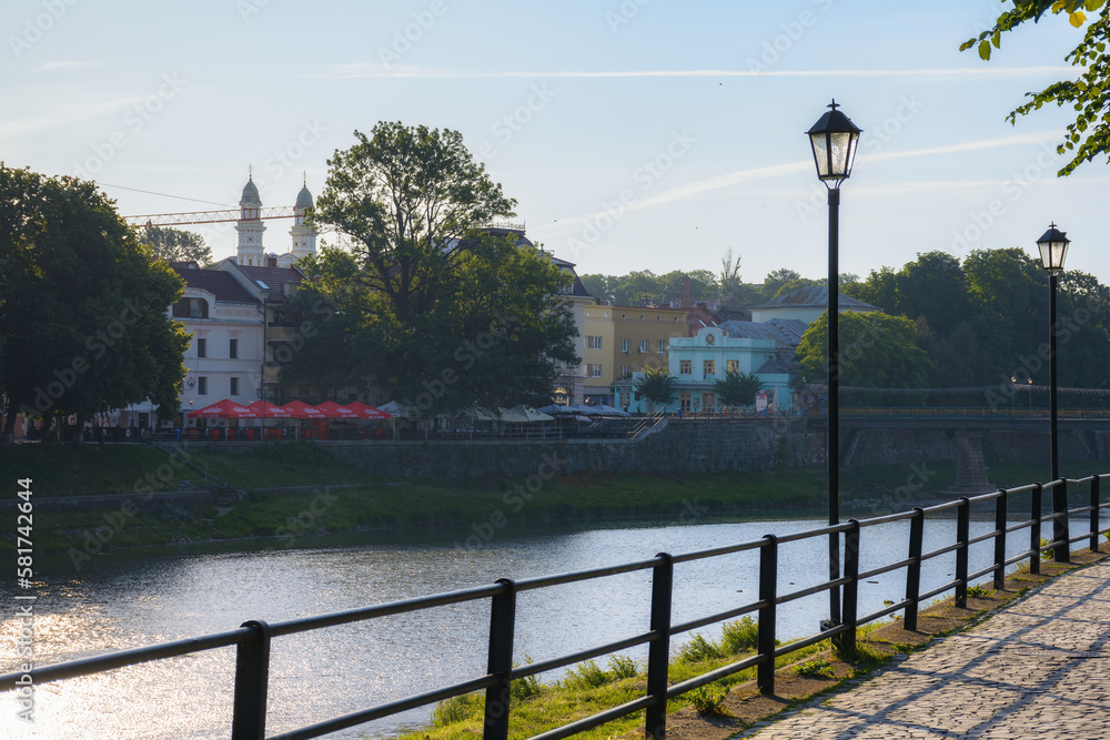 waterfront of the river uzh with lanterns. urban scenery at sunrise