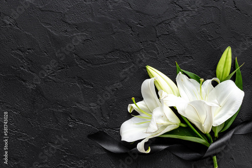 Mourning or funeral concept with white liles and black ribbon photo