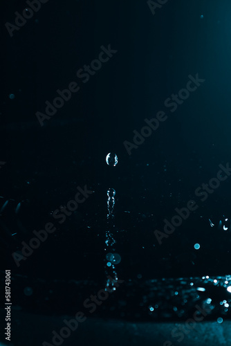 Water drop splash close up on dark background.