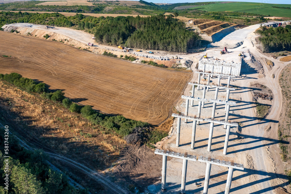 Fototapeta premium Construction of a new road and bridge.Concrete new bridge supports.