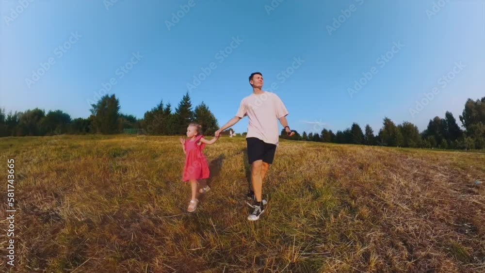 Dad and daughter are walking in the field, father and daughter are having fun in nature, daughter and father are walking in nature, shooting on a 360 camera Dad and daughter are walking in the field, father and daughter are having fun in nature, daughter and father are walking in nature, shooting on a 360 camera