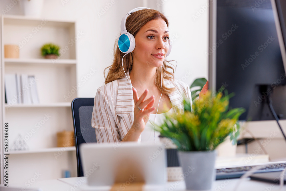Woman having online meeting while working in an office Woman having online meeting while working in an office
