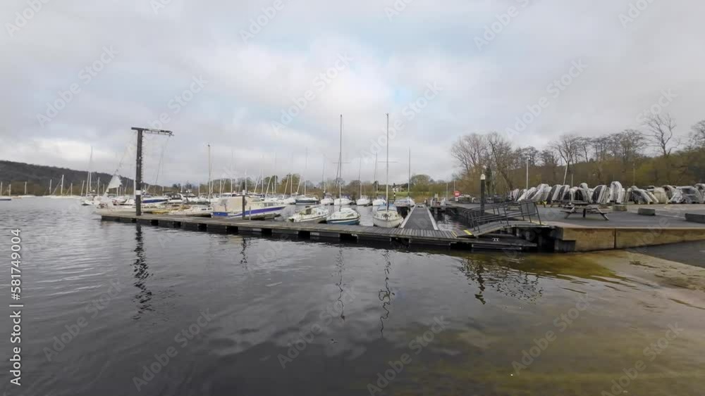 Boats, sailing ships, moored on the harbor of Bowness-on-Windermere. Lake Windermere in the Lake District National Park, UK Boats, sailing ships, moored on the harbor of Bowness-on-Windermere. Lake Windermere in the Lake District National Park, UK