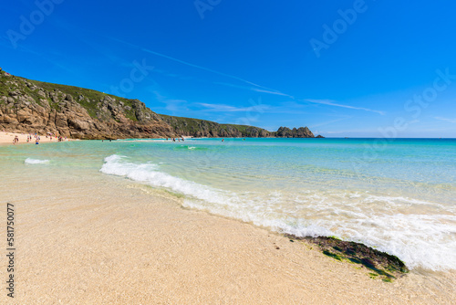Porthcurno beach, picturesque retreat featuring turquoise waters, surrounding granite cliffs and golden sand. Cornwall, England UK © Roberto