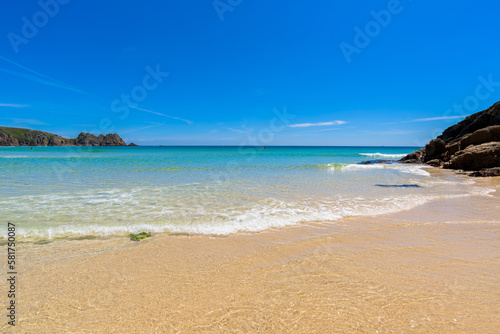Porthcurno beach  picturesque retreat featuring turquoise waters  surrounding granite cliffs and golden sand. Cornwall  England UK