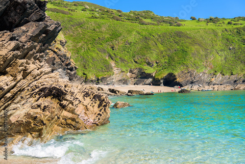 Stunning coastline and beach at Lantic Bay. Crystal clear turquoise sea water in Cornwall, England.