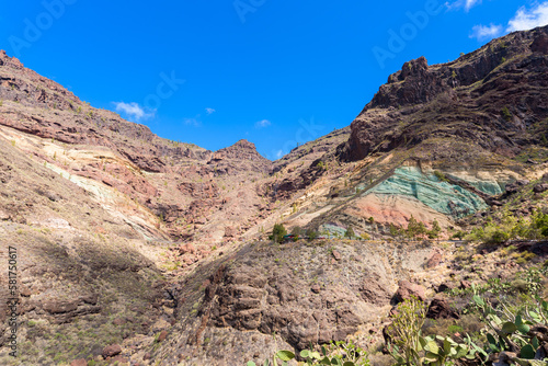 Monumento Natural Azulejos de Veneguera, also known as Rainbow Rocks in Mogán, Las Palmas, Gran Canaria, Spain.
