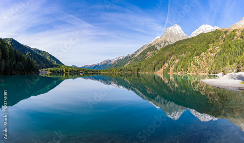 Morning light and still water with reflections at Lake Anterselva, also known as AntholzerSee or Lake Antholz, in South Tyrol, Italy. photo