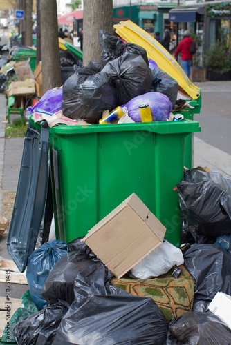 over-consumption, pollution and garbage containers bursting with plastic rubbish