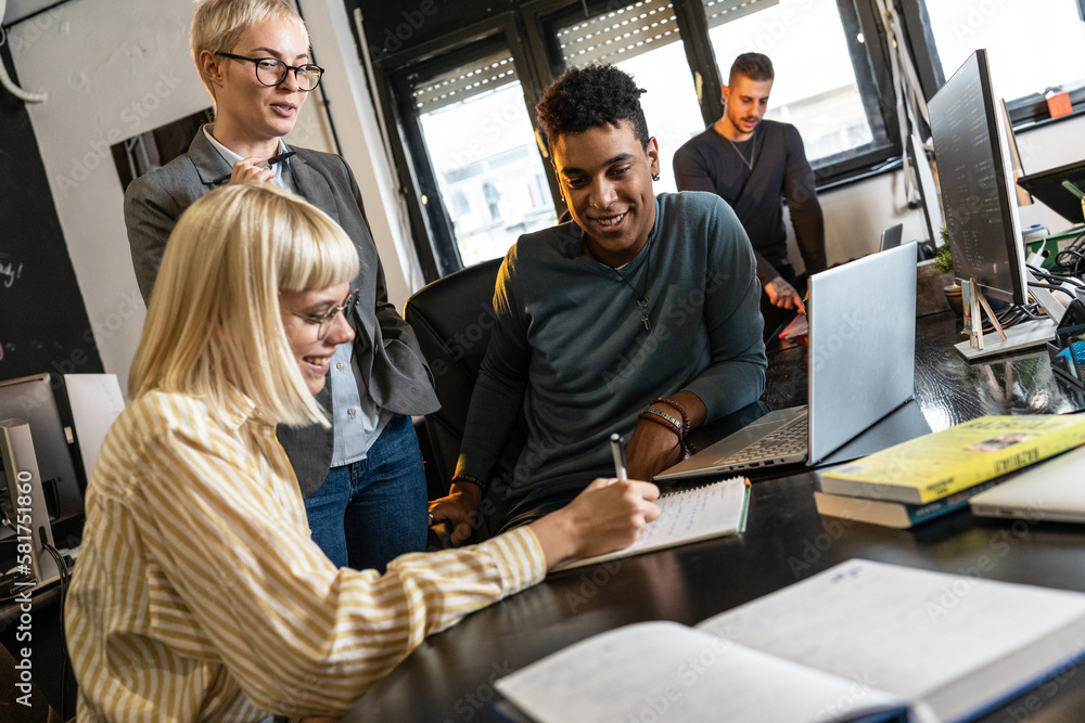 Group of casual team workers and programmers in the office working on a new project. 
