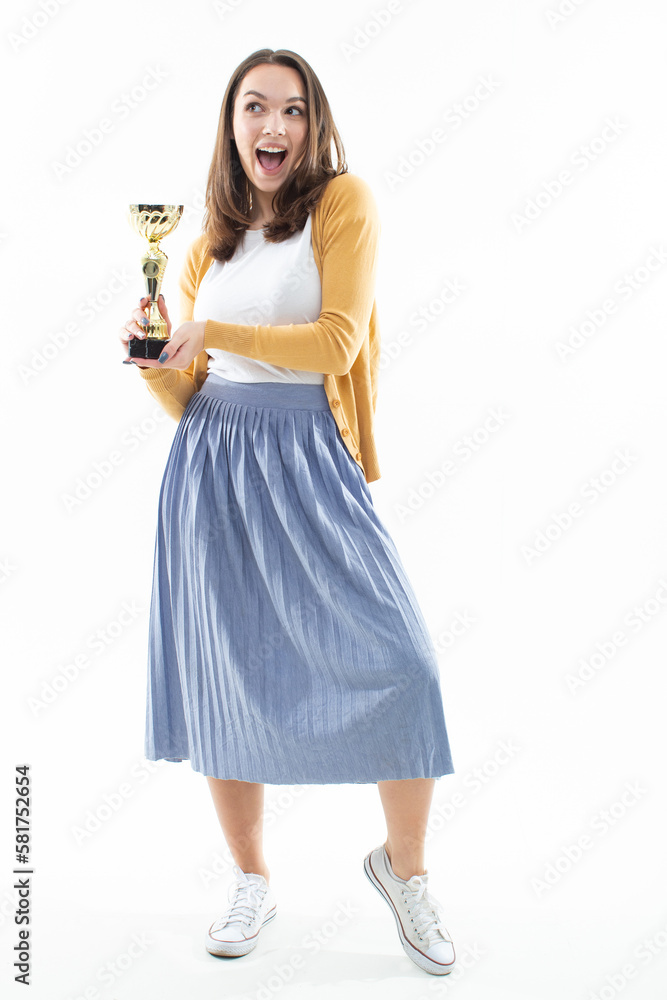 An emotional portrait of a young woman with a gold cup winner. Competition concept An emotional portrait of a young woman with a gold cup winner. Competition concept