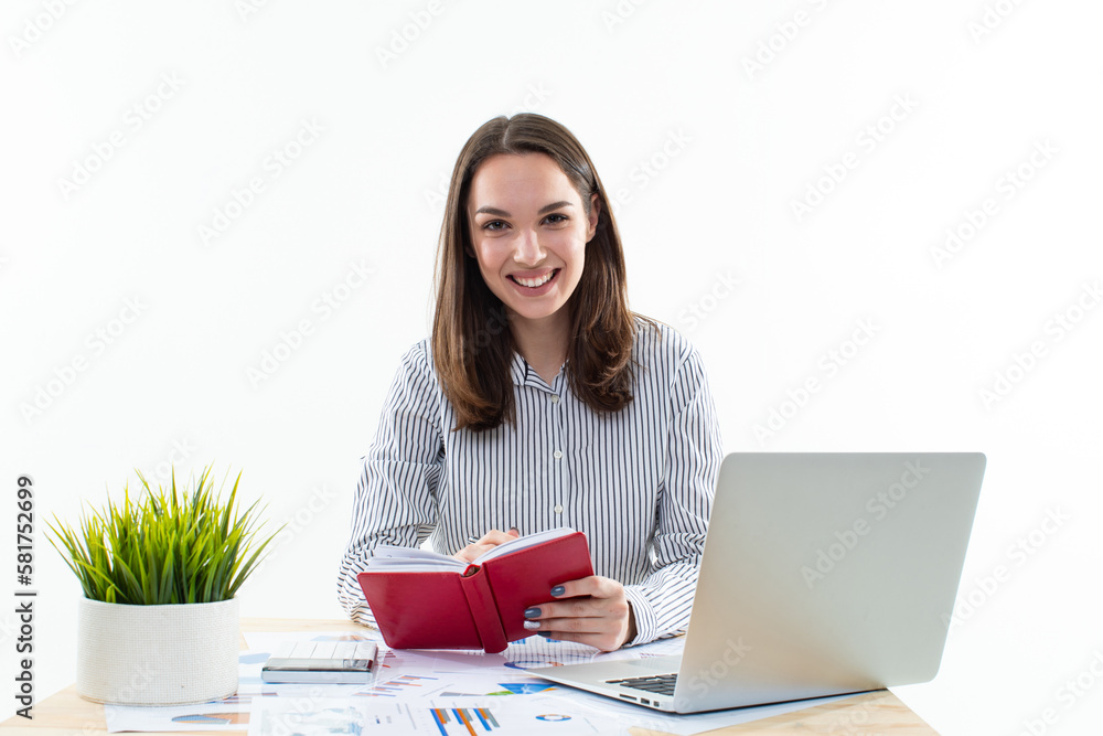 A focused young professional is diligently working on her laptop while surrounded by important documents on a white background A focused young professional is diligently working on her laptop while surrounded by important documents on a white background