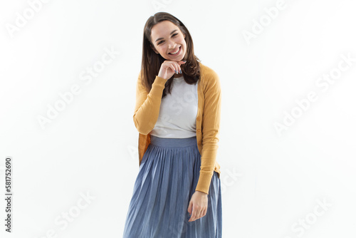 Laughing young woman in a blue skirt and yellow blouse on a white background