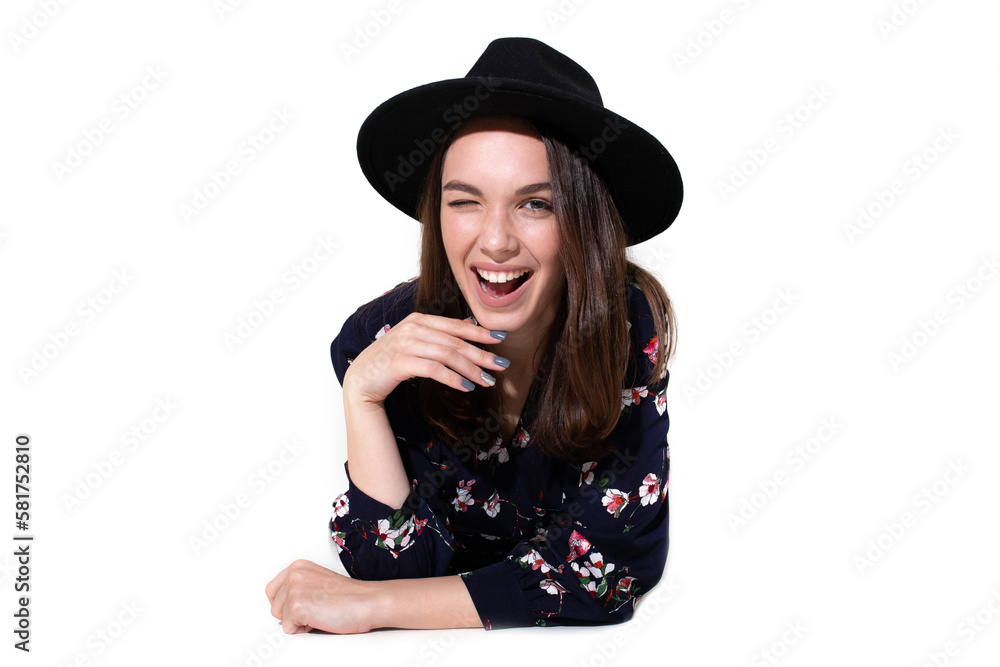 Stunning young woman poses in a beautiful dress and stylish hat against a clean white background Stunning young woman poses in a beautiful dress and stylish hat against a clean white background