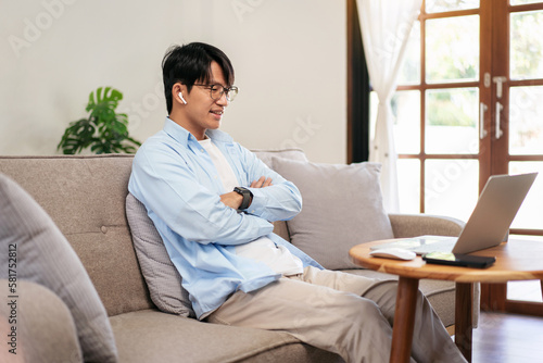 Businessman in casual is sitting with arm crossed on comfortable photo