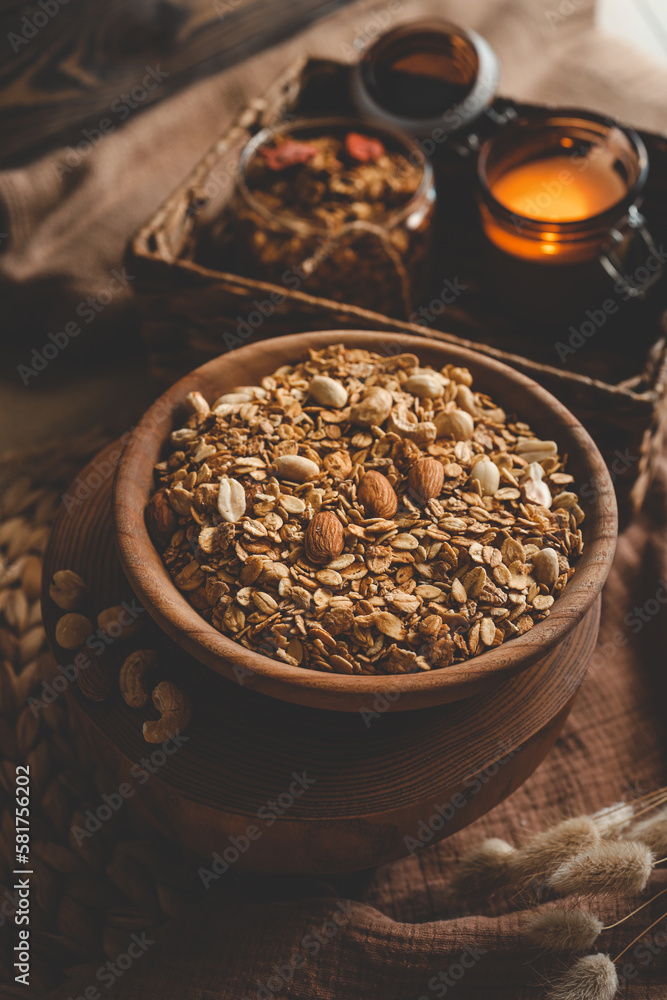 Homemade granola in a wooden bowl in a homely atmosphere Homemade granola in a wooden bowl in a homely atmosphere