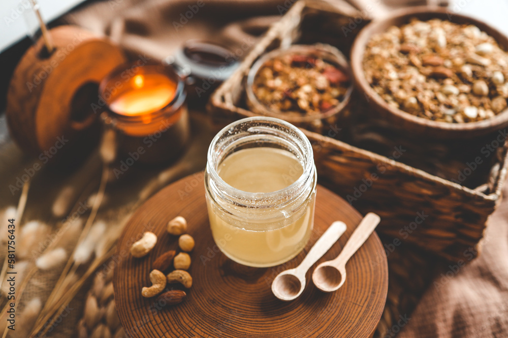Jar with natural honey on granola background, good morning concept Jar with natural honey on granola background, good morning concept