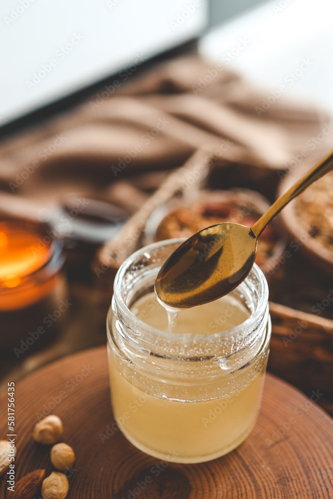 Jar with natural honey on granola background, good morning concept Jar with natural honey on granola background, good morning concept
