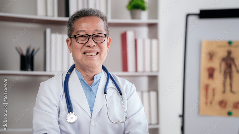 Confident senior male doctor with stethoscope to working on lapt Confident senior male doctor with stethoscope to working on lapt
