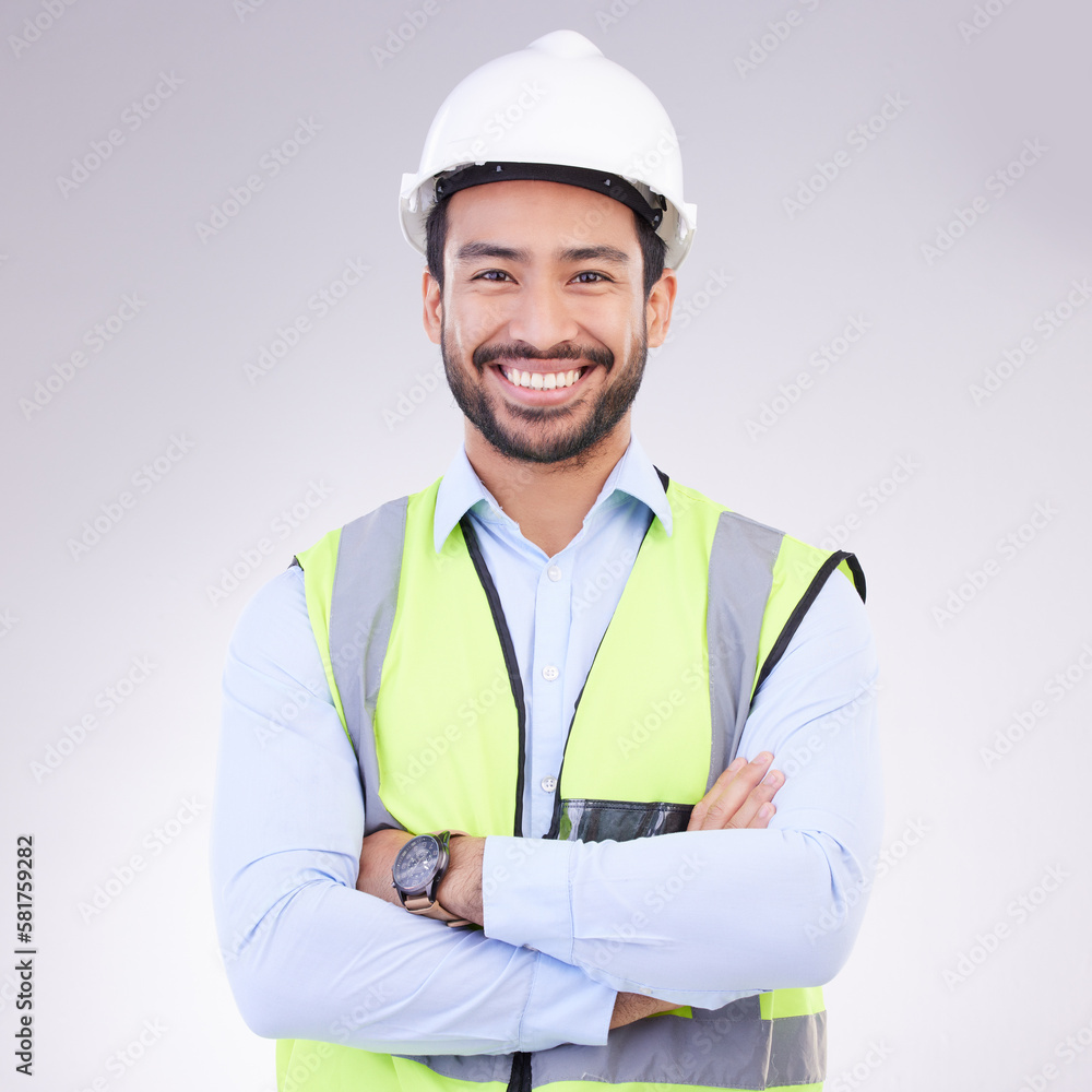 Construction worker in portrait, man with crossed arms and smile, architect or engineer in building industry on studio background. Happy male contractor, mockup and professional builder with helmet