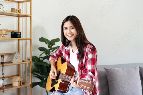 Young woman is practice basic guitar chords for singing the song
