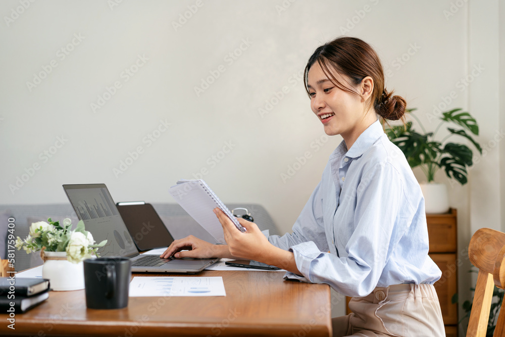 Female freelance is reading information of business on notebook Female freelance is reading information of business on notebook
