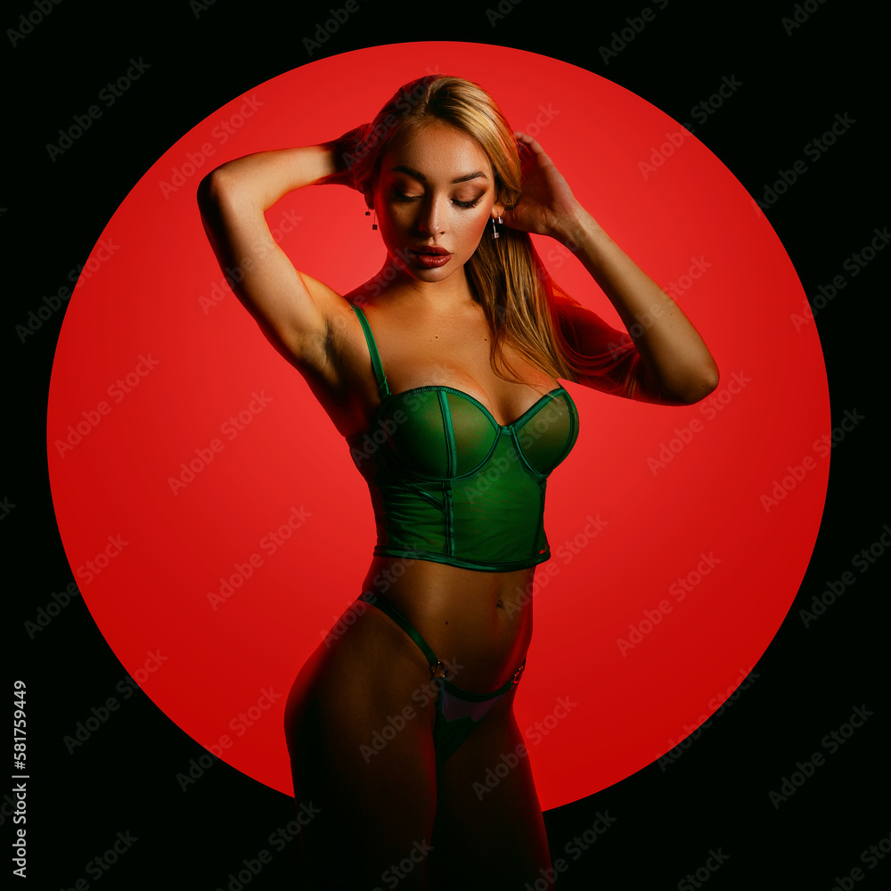 Fashion art photo of elegant model in seductive green lingerie with light neon colored club spotlights