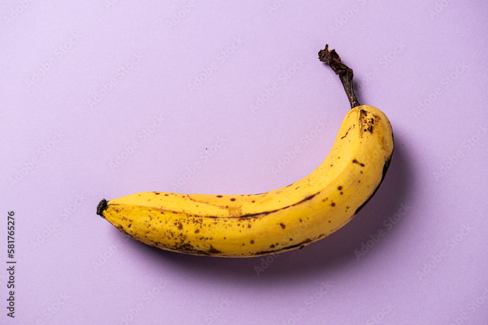 A ripe and yellow banana on a table. A ripe and yellow banana on a table.