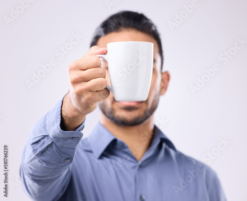 Hand, coffee cup and studio with business man for drink, energy and health to start morning by background. Businessman, young entrepreneur and holding mug for tea, latte or matcha by gray backdrop