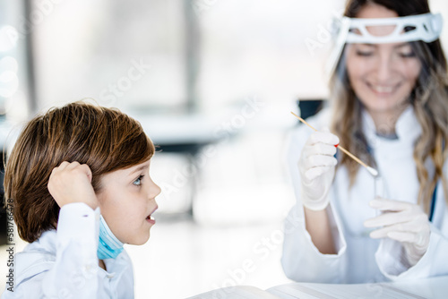 Little boy talking to a nurse in the doctors office