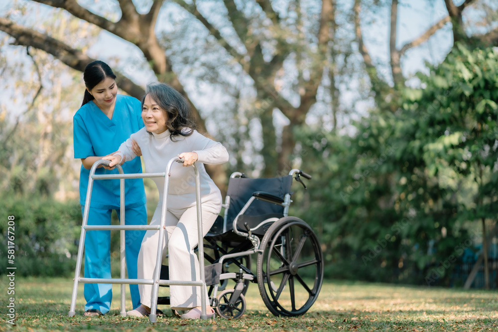 Smiling physiotherapist taking care of the happy senior patient in wheelchair, outdoor. Smiling physiotherapist taking care of the happy senior patient in wheelchair, outdoor.