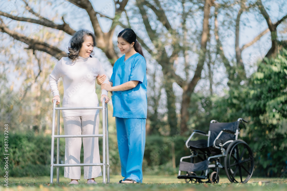 Smiling physiotherapist taking care of the happy senior patient in wheelchair, outdoor. Smiling physiotherapist taking care of the happy senior patient in wheelchair, outdoor.