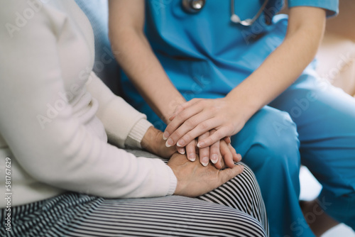 Female doctors shake hands with patients encouraging each other  To offer love, concern, and encouragement while checking the patient's health. concept of medicine. © NINENII