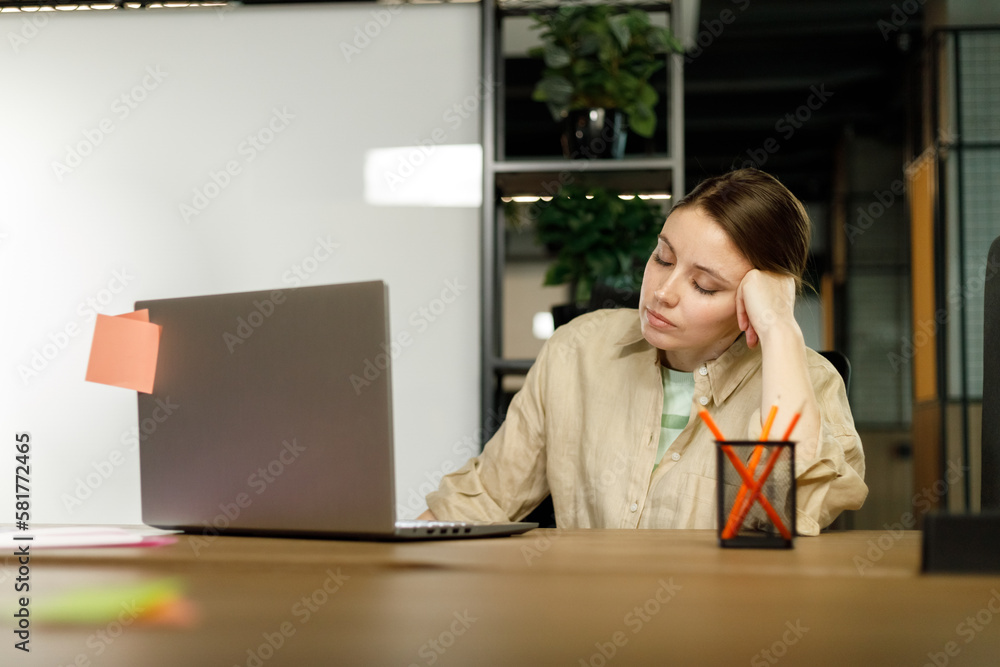 Exhausted businesswoman having a headache at office. creative woman working at office desk feeling tired. Stressed casual business woman feeling eye pain while overworking on desktop computer Exhausted businesswoman having a headache at office. creative woman working at office desk feeling tired. Stressed casual business woman feeling eye pain while overworking on desktop computer