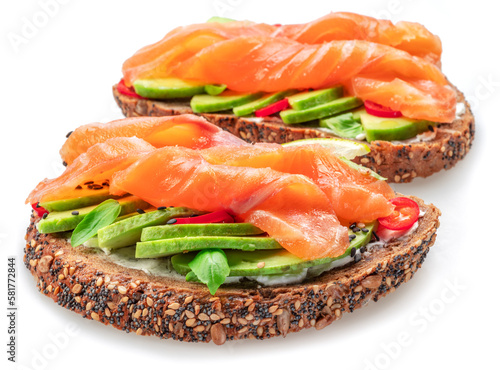 Salmon toasts with avocado isolated on white background. Top view.
