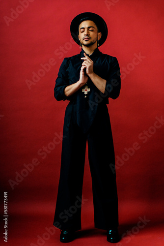 Full-length portrait non-conforming person wearing black outfit