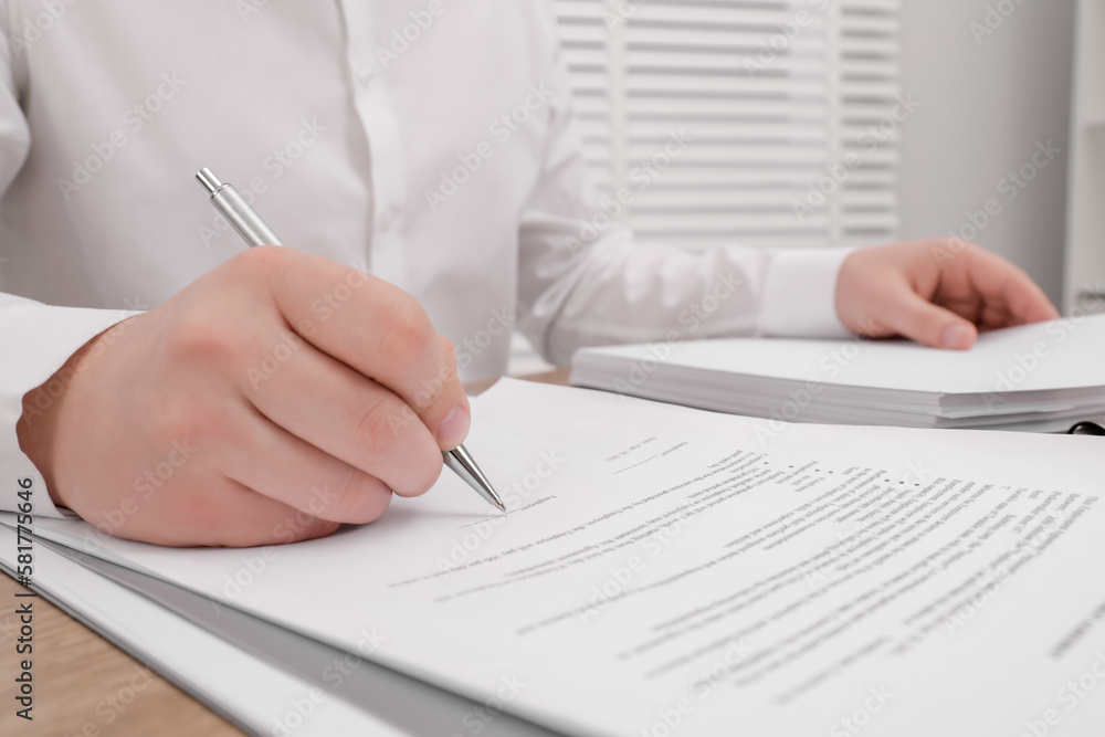 Man signing document at table, closeup view Man signing document at table, closeup view