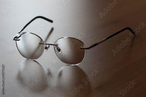 glasses and reading glasses on wooden table