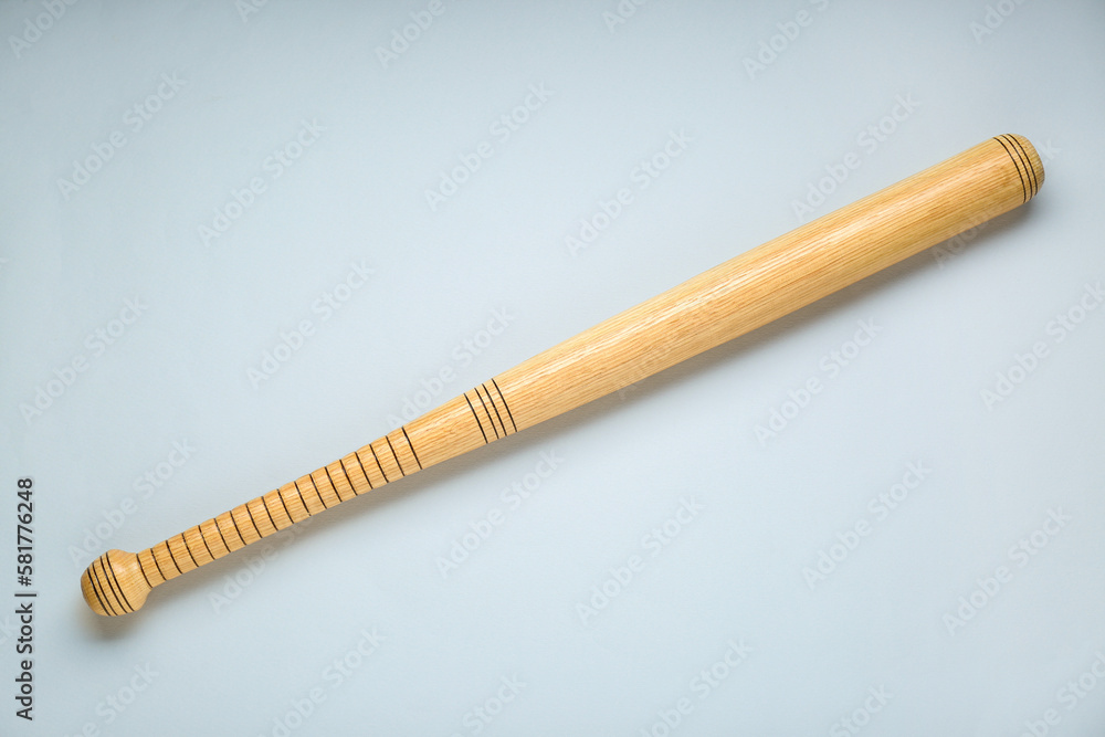Wooden baseball bat on light grey background, top view. Sports equipment Wooden baseball bat on light grey background, top view. Sports equipment