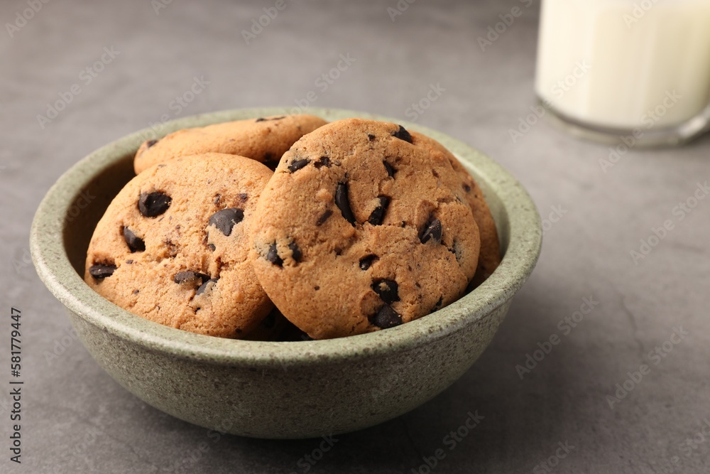 Delicious chocolate chip cookies and milk on grey table, closeup Delicious chocolate chip cookies and milk on grey table, closeup