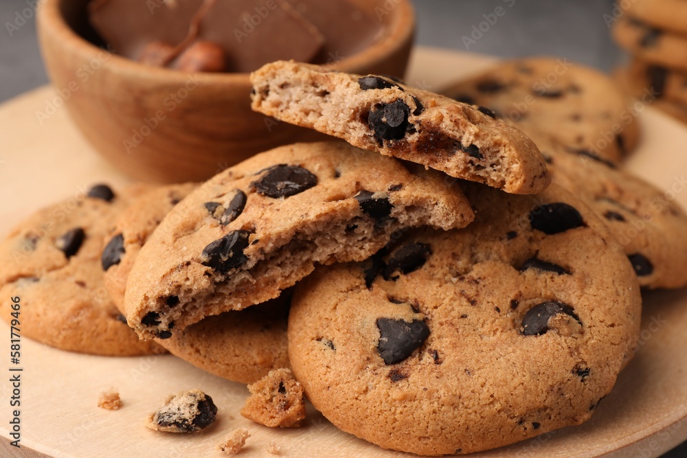 Delicious chocolate chip cookies on wooden tray, closeup Delicious chocolate chip cookies on wooden tray, closeup