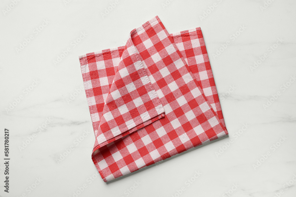 Red checkered tablecloth on white marble table, top view Red checkered tablecloth on white marble table, top view