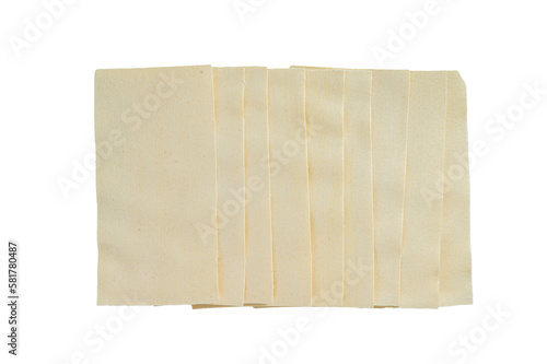 Raw lasagna sheets stack on a kitchen table. Isolated, transparent background.