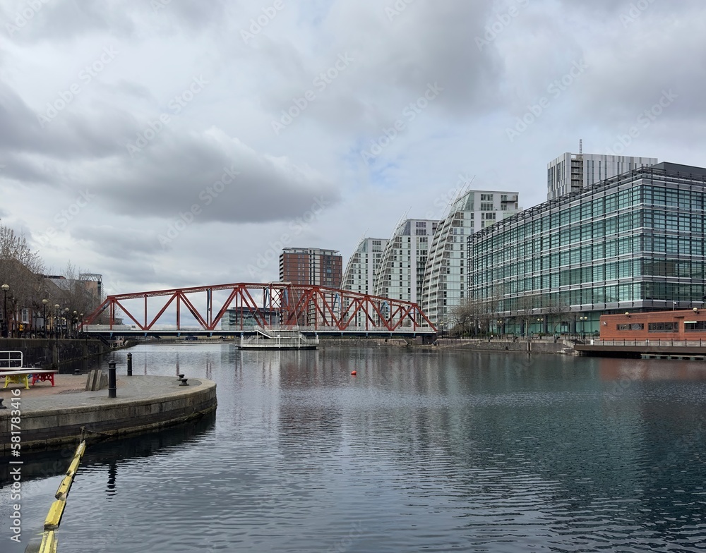 Modern buildings next to the river with reflections in the water. Salford Quays England. 